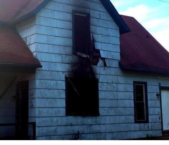 a home that has had fire damage with soot around the windows